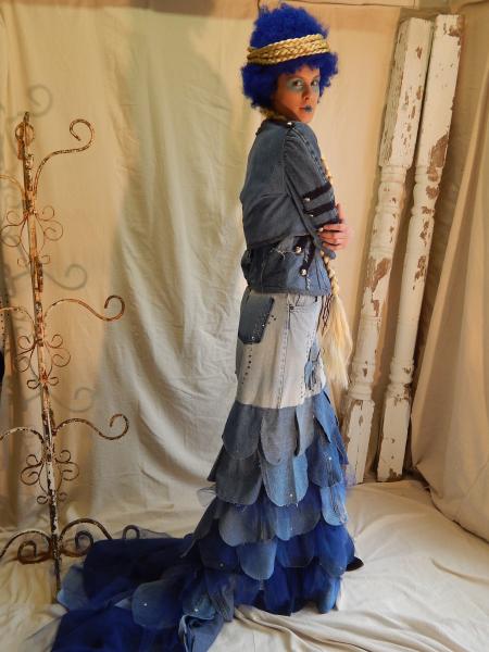 20200, 20201, & 20202 Meghan Three-piece Denim Formal consists of a denim skirt with fabric flower, sequins, and tulle with a detachable train; a leather laced denim corset; and a denim bolero jacket. All are made from pre-loved denim jeans in varying levels of bleaching and distressing.